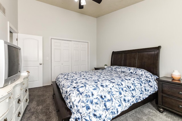 bedroom with a closet, a ceiling fan, visible vents, and dark colored carpet