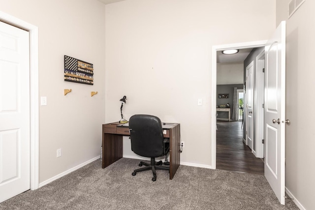 home office with carpet floors, baseboards, and visible vents