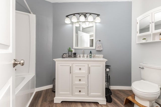 full bath featuring baseboards, wood finished floors, and toilet