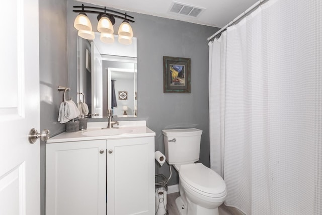full bath with visible vents, toilet, and vanity