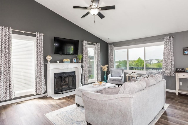 living room with visible vents, lofted ceiling, wood finished floors, a fireplace, and ceiling fan