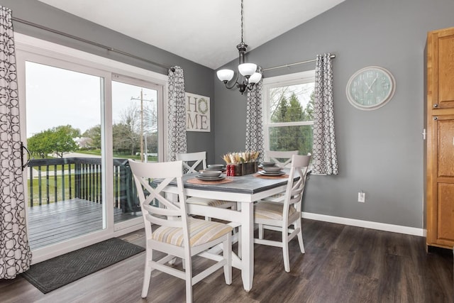 dining area featuring baseboards, an inviting chandelier, dark wood-style floors, and lofted ceiling