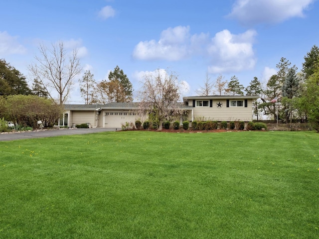 27241 W Nippersink Rd, Ingleside, IL 60041 - split level home with a garage, a front lawn, and aphalt driveway