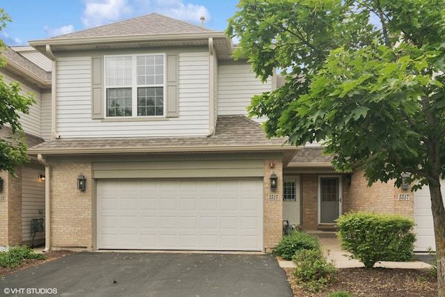 5515 Mcdonough Rd Unit 5515, Hoffman Estates, IL 60192 - view of front of property featuring asphalt driveway, brick siding, an attached garage, and a shingled roof