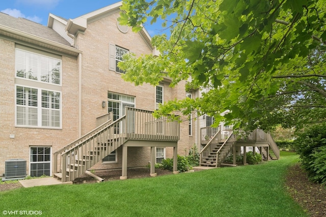 5515 Mcdonough Rd Unit 5515, Hoffman Estates, IL 60192 - rear view of property with stairway, central air condition unit, a yard, and brick siding