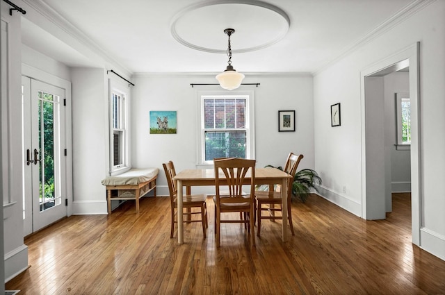 dining space with a healthy amount of sunlight and hardwood / wood-style floors