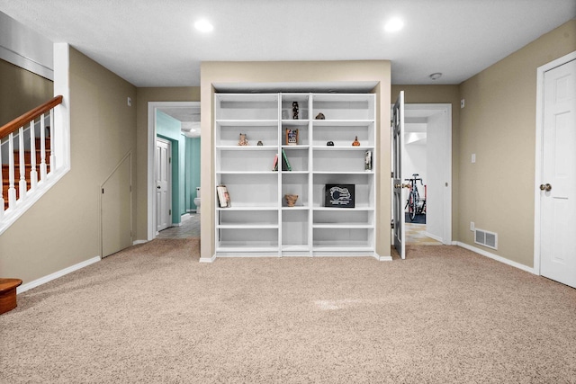 unfurnished bedroom with baseboards, visible vents, and carpet