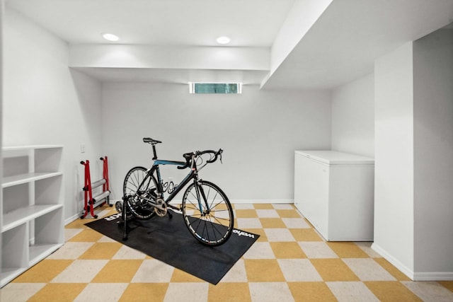 workout room featuring light floors, baseboards, and recessed lighting