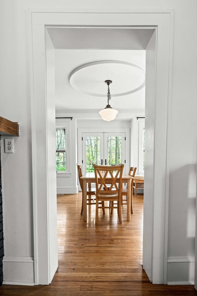dining space with french doors and wood finished floors