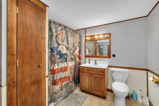 bathroom with crown molding, toilet, a shower with curtain, and vanity