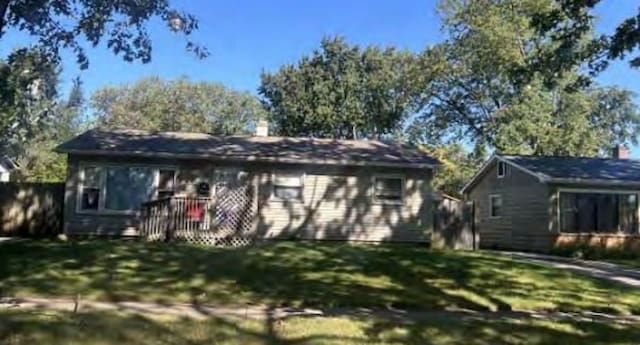 back of house with a yard and fence