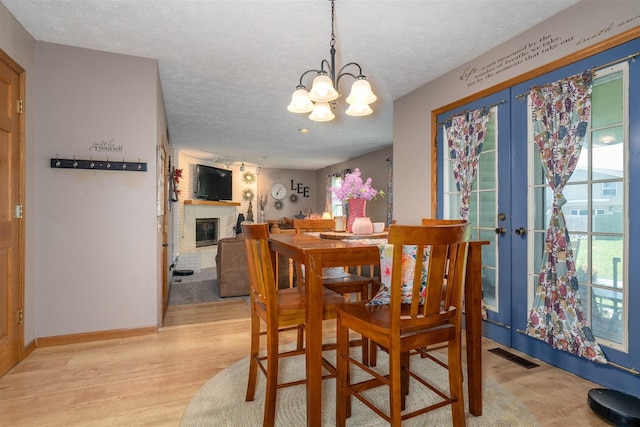 1107 N Bailey Dr, Pontiac, IL 61764 - dining room with a textured ceiling, french doors, light wood-style flooring, and healthy amount of natural light