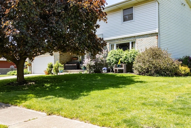 1107 N Bailey Dr, Pontiac, IL 61764 - view of front facade with a front lawn, brick siding, and an attached garage