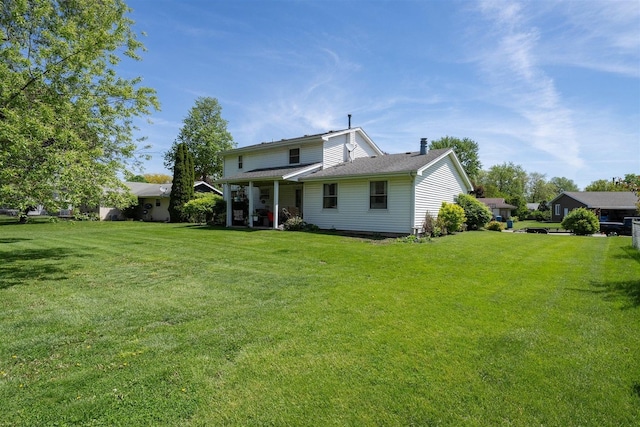 1107 N Bailey Dr, Pontiac, IL 61764 - back of property with a yard and a chimney