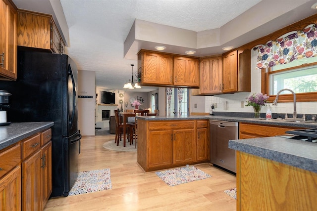 1107 N Bailey Dr, Pontiac, IL 61764 - kitchen with dishwasher, a sink, brown cabinets, light wood-style flooring, and freestanding refrigerator