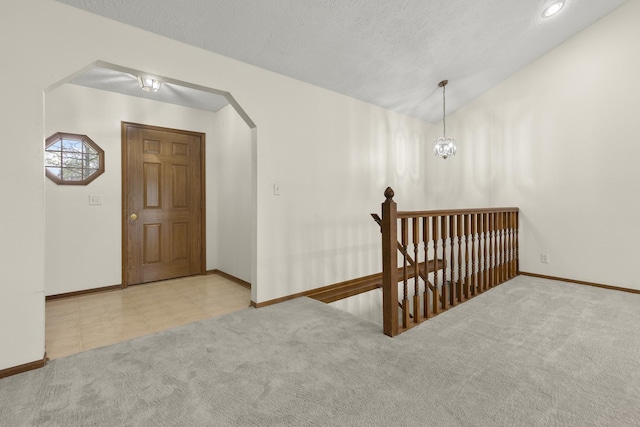 bonus room with carpet floors, arched walkways, baseboards, and lofted ceiling