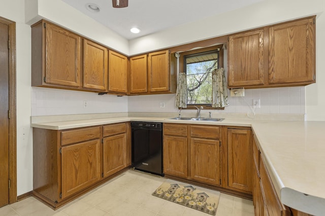 kitchen with a sink, black dishwasher, brown cabinets, and light countertops