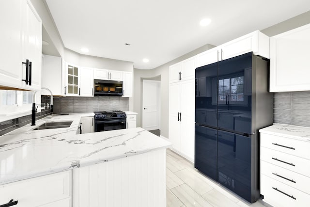 4424 Maple Ave, Brookfield, IL 60513 - kitchen featuring a sink, black appliances, light stone countertops, and tasteful backsplash