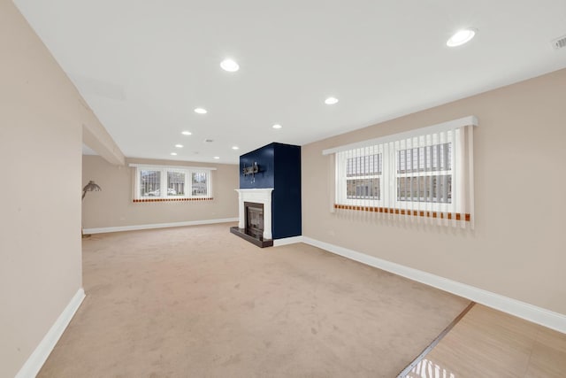4424 Maple Ave, Brookfield, IL 60513 - unfurnished living room featuring baseboards, a fireplace with raised hearth, and a healthy amount of sunlight