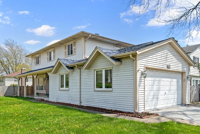 view of front of home featuring an attached garage, fence, driveway, and a front yard