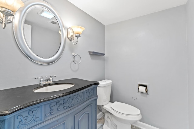 bathroom with visible vents, toilet, and vanity