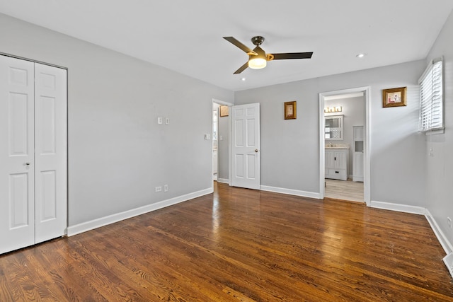 unfurnished bedroom featuring recessed lighting, baseboards, wood finished floors, and ensuite bathroom