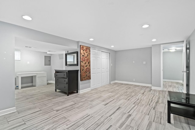 interior space featuring electric panel, visible vents, baseboards, light wood-style floors, and recessed lighting
