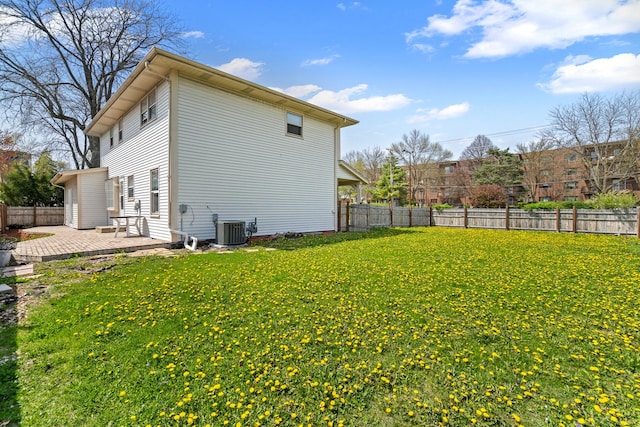 exterior space featuring a lawn, central AC, a fenced backyard, and a patio area