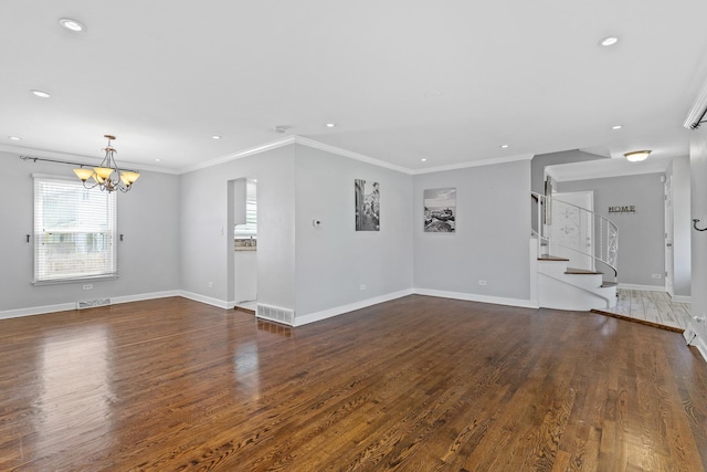 unfurnished living room with an inviting chandelier, ornamental molding, wood finished floors, and visible vents