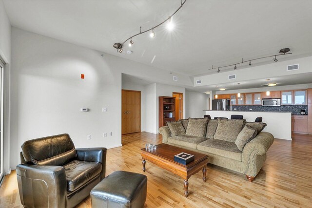 living room featuring track lighting and light wood-style floors