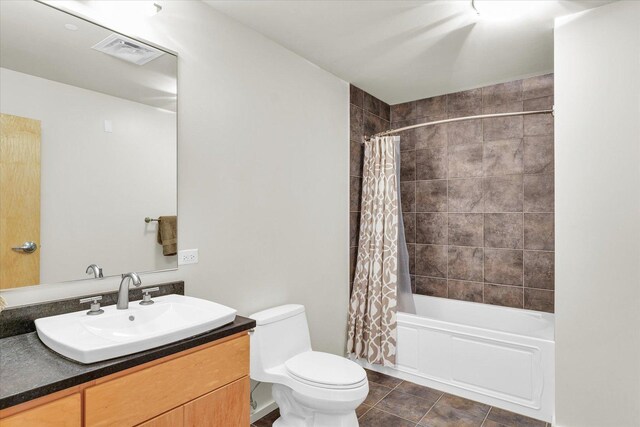 full bath with toilet, shower / bath combo with shower curtain, tile patterned flooring, and vanity
