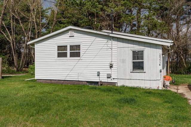 view of side of home with a lawn