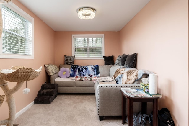 living room with baseboards and light colored carpet