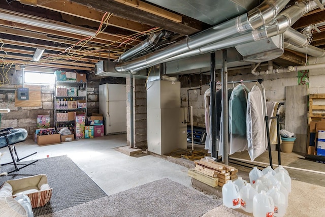 below grade area featuring freestanding refrigerator