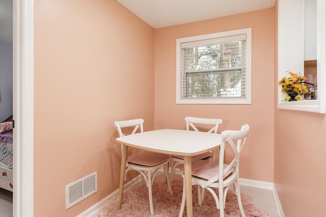 dining space featuring baseboards and visible vents