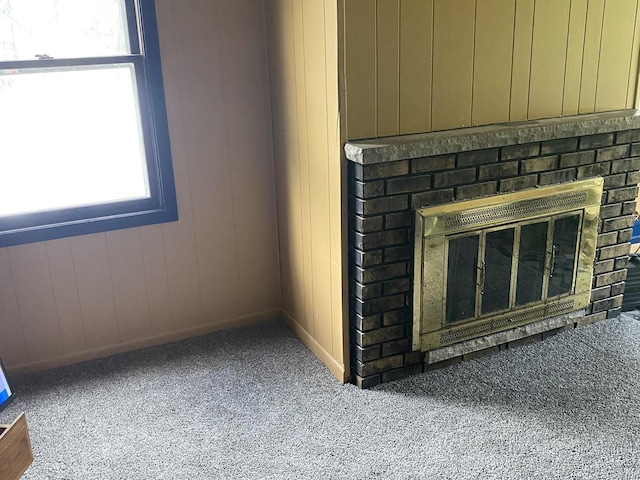 room details featuring carpet floors, baseboards, and a brick fireplace