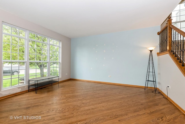 685 Veronica Ct, New Lenox, IL 60451 - unfurnished living room featuring baseboards, wood finished floors, and healthy amount of natural light