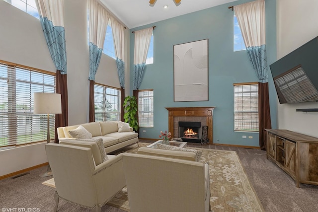 685 Veronica Ct, New Lenox, IL 60451 - carpeted living room with a towering ceiling, baseboards, a tile fireplace, and a ceiling fan
