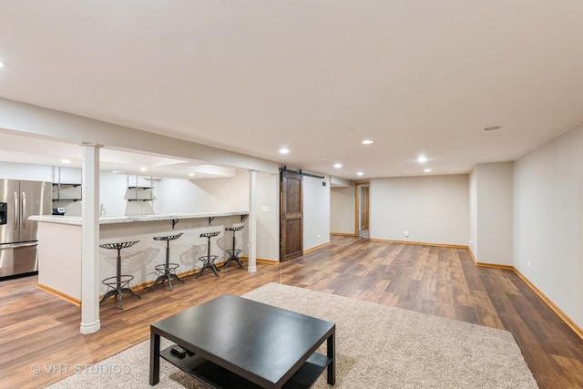 685 Veronica Ct, New Lenox, IL 60451 - finished basement featuring stainless steel fridge, wood finished floors, bar area, recessed lighting, and a barn door