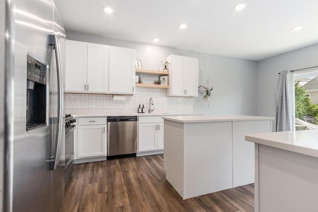 kitchen with appliances with stainless steel finishes, light countertops, open shelves, dark wood-style flooring, and tasteful backsplash