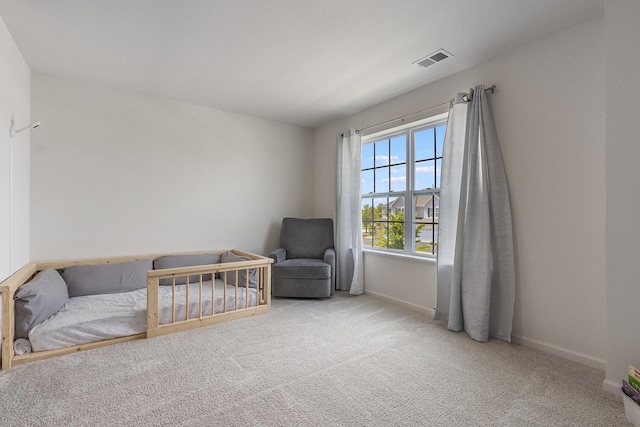 sitting room with baseboards and carpet flooring