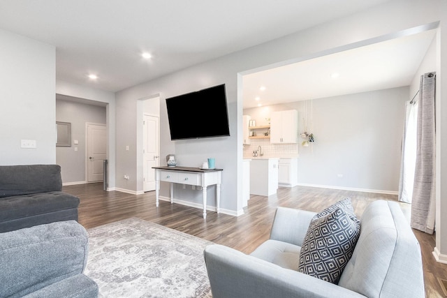 living room with wood finished floors, recessed lighting, and baseboards