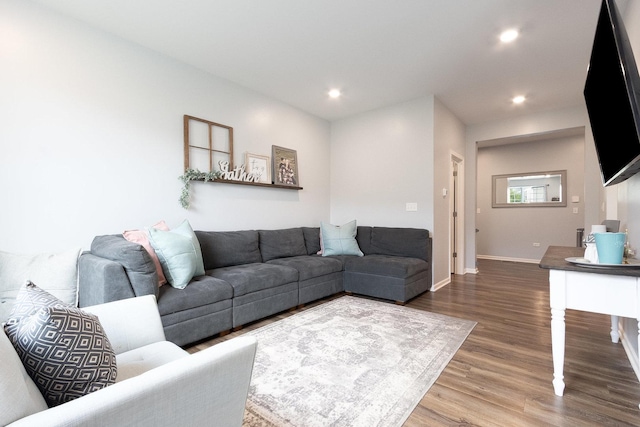 living area with wood finished floors, recessed lighting, and baseboards