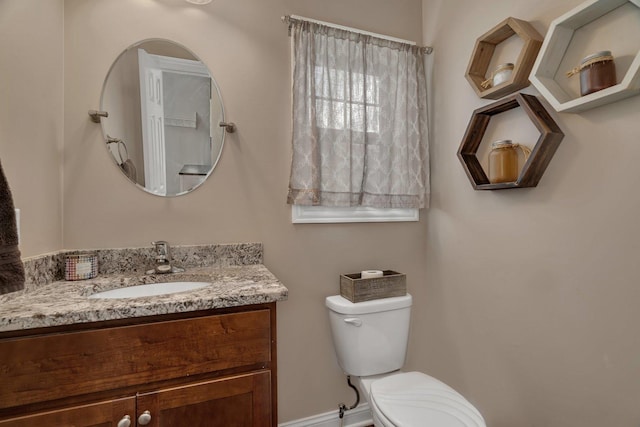 half bath featuring toilet and vanity