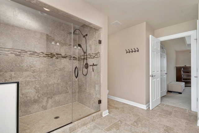 bathroom with baseboards and a shower stall