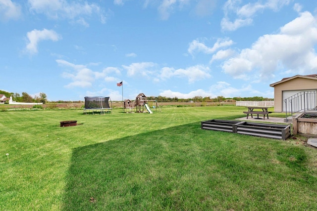 view of yard featuring a playground, fence, and a trampoline