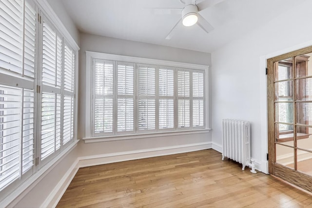 1431 W Rascher Ave Unit 1W, Chicago, IL 60640 - spare room featuring radiator heating unit, wood finished floors, ceiling fan, and baseboards