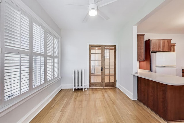 1431 W Rascher Ave Unit 1W, Chicago, IL 60640 - unfurnished dining area featuring radiator heating unit, french doors, light wood-style flooring, and baseboards