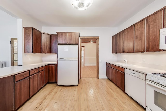 1431 W Rascher Ave Unit 1W, Chicago, IL 60640 - kitchen with white appliances, light countertops, light wood-style floors, and a sink