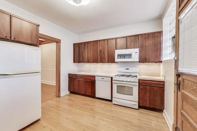 1431 W Rascher Ave Unit 1W, Chicago, IL 60640 - kitchen with white appliances, light countertops, light wood-style flooring, and baseboards